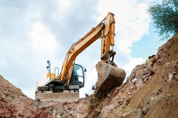 Excavator Performs Excavation Work In Clay Stock Photo, Picture and Royalty  Free Image. Image 99734842.