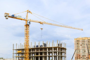 Bir inşaatta çalışan vinçler. Bir ev inşaatı.