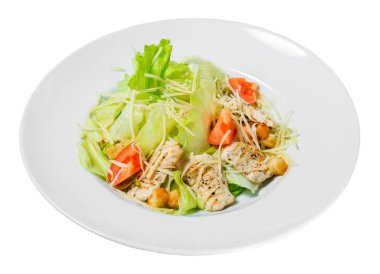 Salad Caesar with Romaine lettuce, tomatoes, grilled chicken, croutons and cheese on a plate. Isolated on white background.