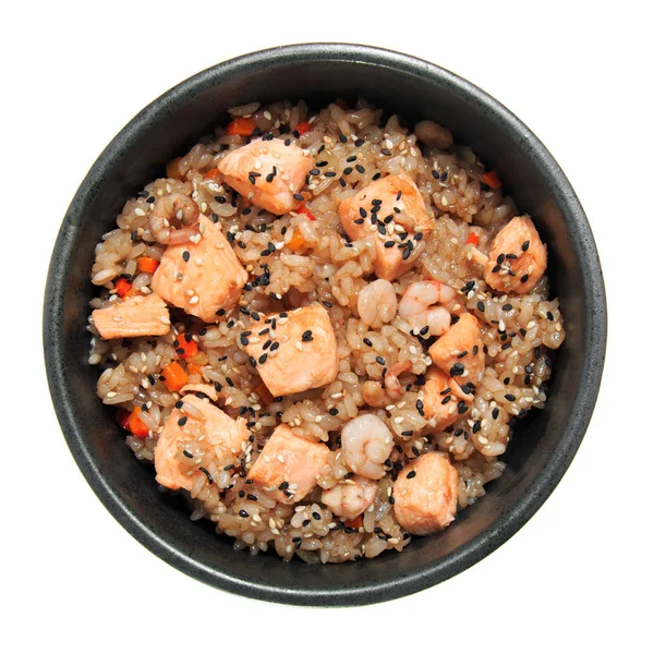 Rice with shrimp, fried salmon and vegetables in the bowl. Isolated on white background. Delicious restaurant dish.