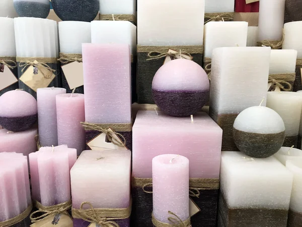 Colored decorative candles at the fair. different size and colors candles. pastel aroma candles. colorful decorative wax candles sell in outdoor marketplace fair