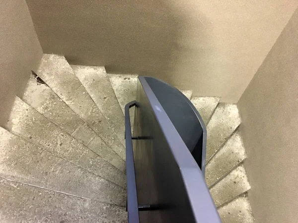 Modern staircase, Staircases in reinforced concrete building, Stainless steel railings inside building, New concrete stairs in office building. Close up and details of railing and stairs
