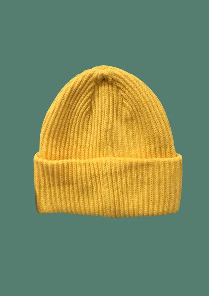 Yellow winter hipster hat pattern isolated on green background. Fashion casual winter hat. Winter Wooly Hat. Winter clothes pattern. Banner concept