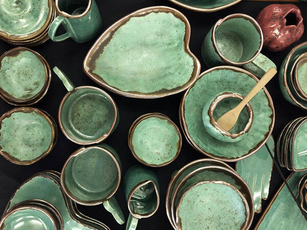 Green handmade ceramic dishes gold rimmed top view. Handmade Serving Bowl. Ceramic bowl with jagged edges. Jagged Mouth Bowl. Designer ceramic plates, bowls, cups and jugs