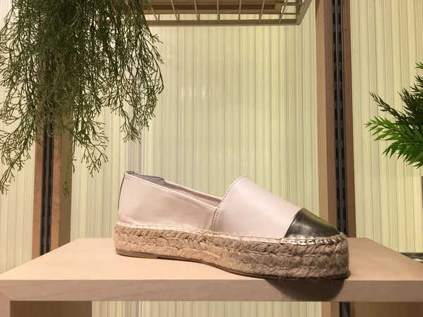 Espadrilles with toecap detail on shelf in shoes store. Mass market shop. Casual Female shoes. Canvas Platform Women\'s Espadrilles. Brightly colored slippers shoes