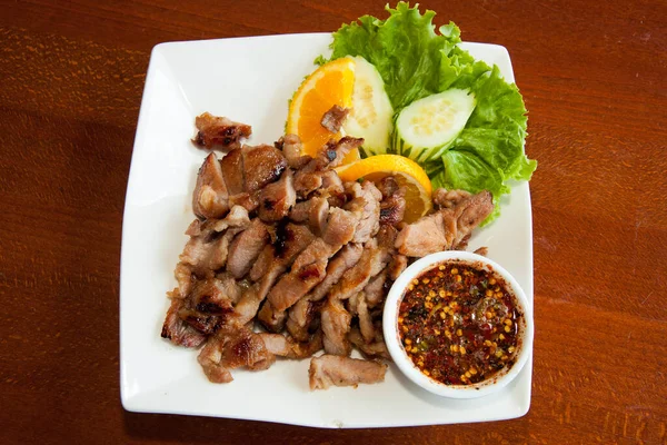 stock image Thai style grilled pork barbecue with spicy sauce.