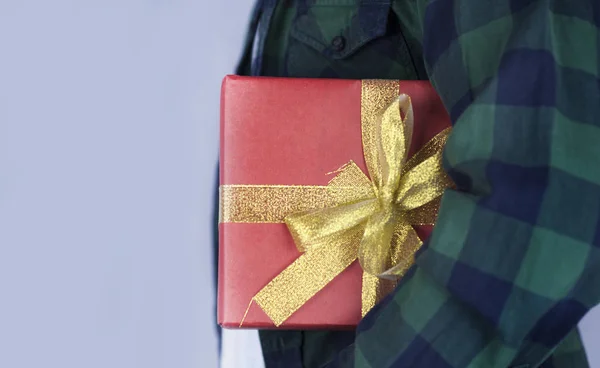 Young Handsome Guy Holds Gift His Hands Close — Stock Photo, Image