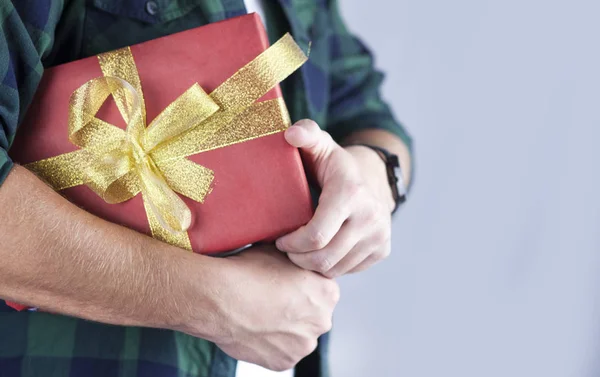 Young Handsome Guy Holds Gift His Hands Close — Stock Photo, Image