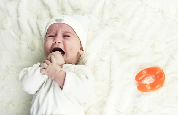 Newborn Newborn baby is crying. The newborn baby is tired and hungry. The kids are crying. Bed linen for children. The baby is screaming. Healthy baby soon after birth.baby is crying.