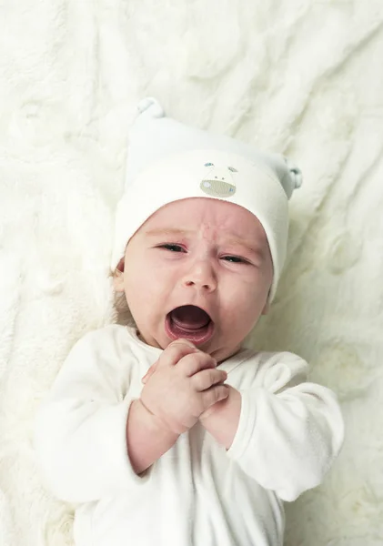 Newborn Newborn baby is crying. The newborn baby is tired and hungry. The kids are crying. Bed linen for children. The baby is screaming. Healthy baby soon after birth.baby is crying.