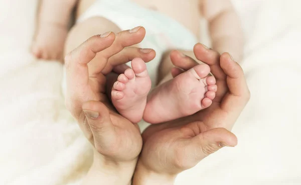 Close Mãe Mão Segurando Recém Nascido Bebê Pés Forma Ouvir — Fotografia de Stock