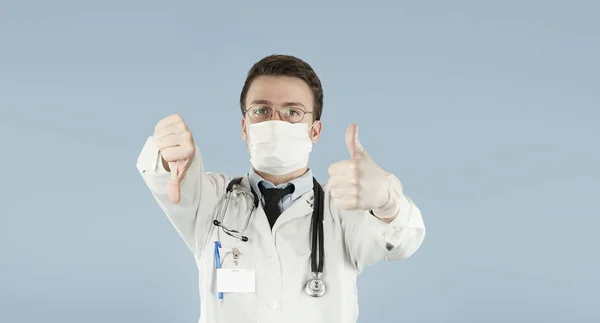 年轻的家伙医生学生在蓝色被隔绝的背景显示拇指 医学与健康的概念 — 图库照片