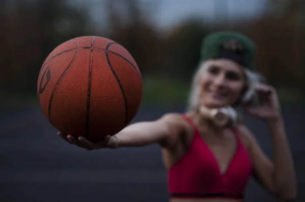 Beautiful Young Sexy Sports Girl Twists One Finger Ball Looking — Stock Photo, Image