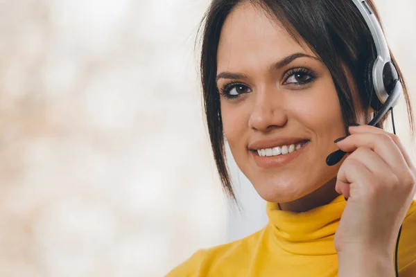 Online customer support, portrait of woman with microphone and headphones.
