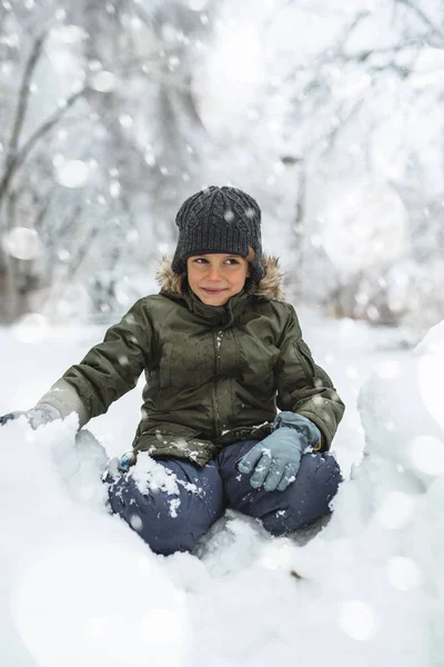 cute little boy playing in snow outdoor