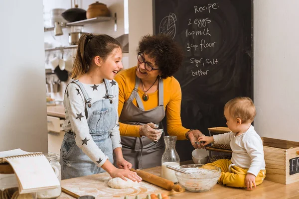 Family baking together in kitchen