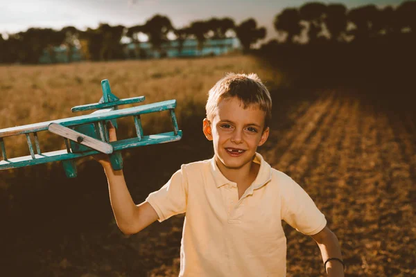 Cute Little Boy Playing Outdoor Wooden Airplane Toy — Stock Photo, Image