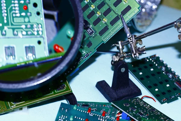 Elektronik bileşenleri devre kartlarına Büyüteç ön planda ile basılmış.