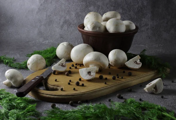 Ingredients for cooking delicious food. champignon mushrooms and fresh green dill. Black pepper peas scattered on the table — Stock Image Ingredients Cooking Delicious Food Champignon Mushrooms Fresh Green Dill Black Stock Picture