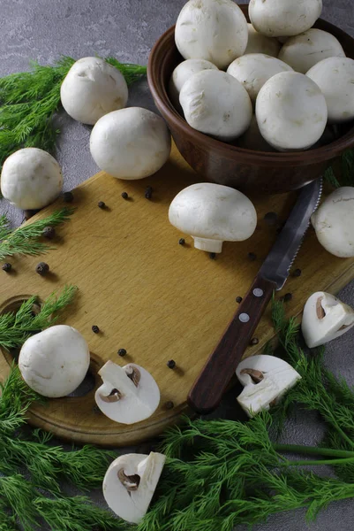 Champignon mushrooms laid out on the board, next to green dill and a knife for cutting. There is open space for text. — Stock Image Champignon Mushrooms Laid Out Board Next Green Dill Knife Cutting Stock Picture