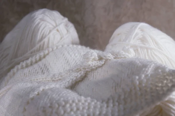 Woven white thread for knitting. White yarn for knitting close-up. knitting patterns.Knitting is a hobby. Knitting texture