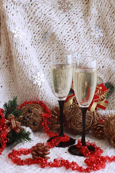 New Year\'s festive picture with glasses of champagne, Christmas toys, green spruce branches, red beads and hearts. 2019