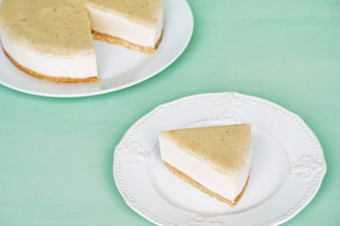 Çiğ glütensiz fırınlanmamış tatlı. Nane yeşili arka planda tuzlu karamel soslu vejetaryen peynirli kek. Tatlı sağlıklı yemek..