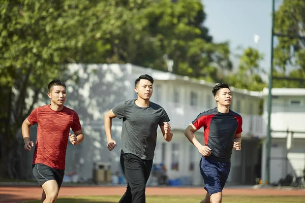 Tres Asiático Jóvenes Adultos Entrenamiento Corriendo Pista —  Fotos de Stock