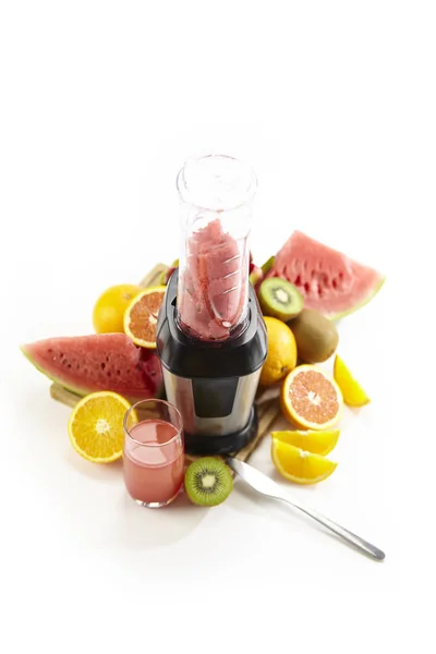 fruits, juice and blender isolated on white background.