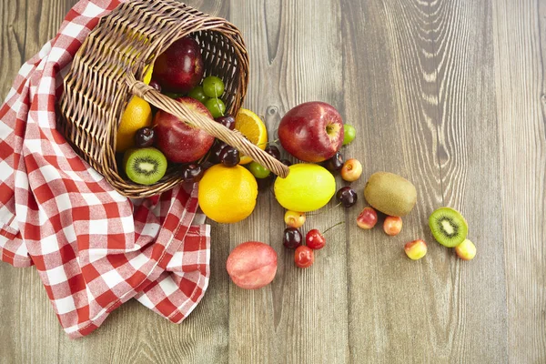 Uma Cesta Frutas Derramadas Superfície Madeira Dura — Fotografia de Stock