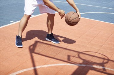 açık sahada top işleme becerileri pratik Genç Asyalı erkek basketbol oyuncusu.