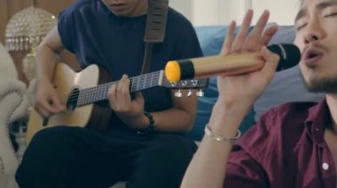 members of a rock band rehearsing at home.