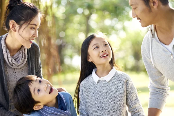 亚洲家庭与两个孩子有乐趣在公园里探索树林 — 图库照片