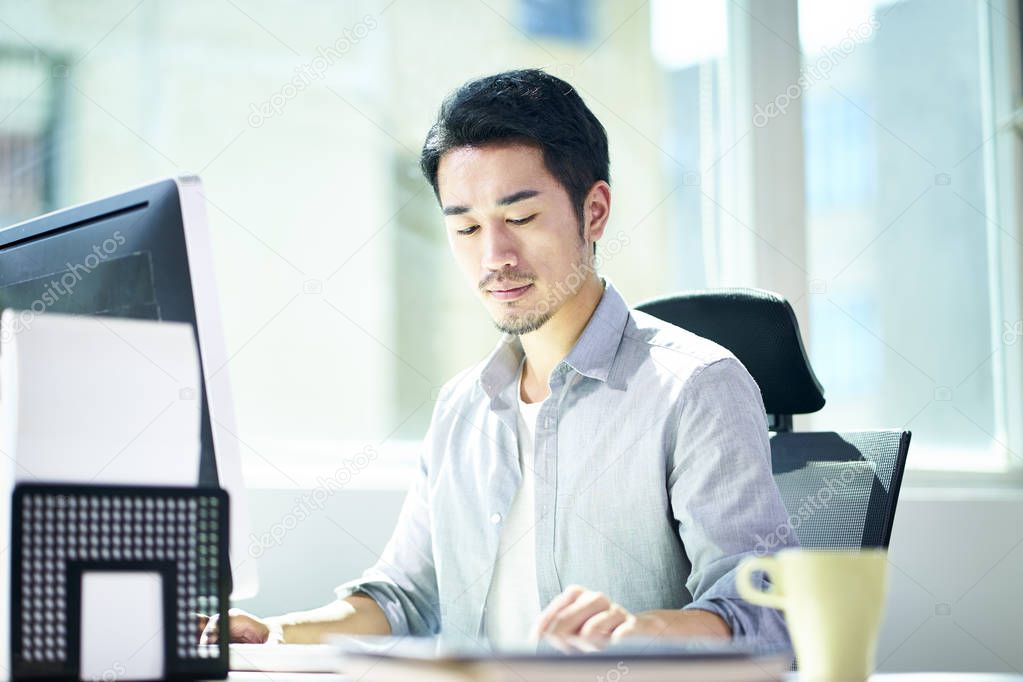 young asian entrepreneur working in office