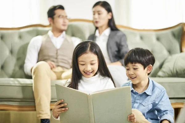 Dos asiático niños lectura libro juntos —  Fotos de Stock