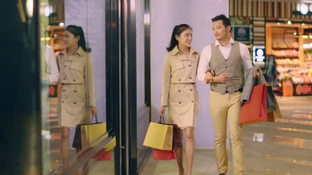 Happy Asian Couple Shoppers Walking Shopping Mall — Stock Video