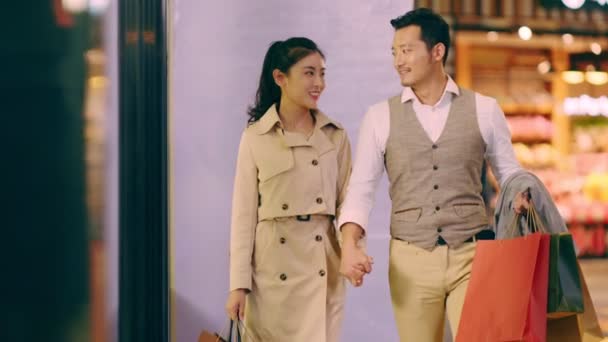 Happy Asian Couple Shoppers Walking Shopping Mall Looking Shop Window — Stock Video