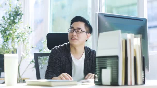 若いアジアのビジネスマンは オフィスで同僚から助けを得る — ストック動画