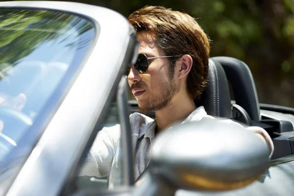 Asian man driving a convertible car — Stock Photo, Image