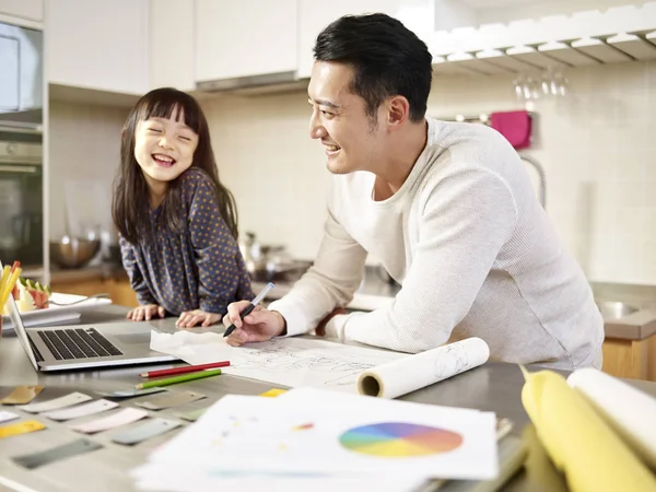 young asian father enjoying working at home