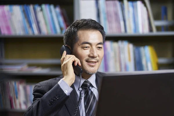 Asiatischer Konzernchef Sitzt Schreibtisch Büro Und Telefoniert — Stockfoto