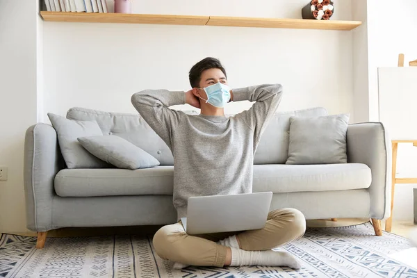 Young Asian Business Man Staying Home Wearing Mask Sitting Carpet — Stock Photo, Image