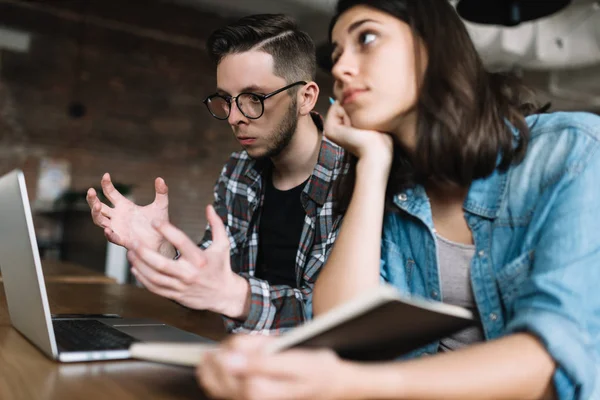 University students researching information online using laptop computer, studying at library. Angry man failed exam. Missed deadline. Stress.