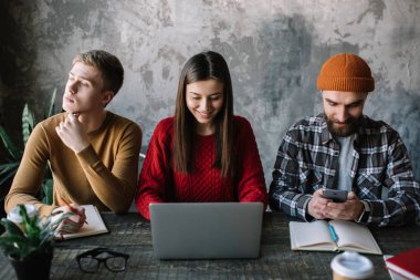 Group of university students learning languages together using laptop, writing notes, typing keyboard. Exam preparation. Online education concept. Creative team of coworkers brainstorming. Meeting. Communication. Collaborate.   clipart