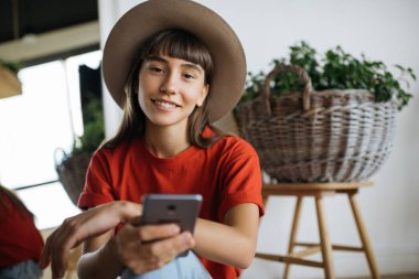 Güzel yüz ve gülümseme check posta kutusu cep telefonu, sohbet, holding ile neşeli gülümseyen iş kadın portresi. Çekici kadın rezervasyon seyahat kullanma Online mobil uygulama. Nakit geri. 