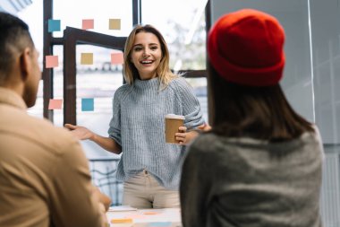 Group of creative business people discussing startup project, brainstorming, collaborate, working together using scrum for successful business. Positive colleagues planning strategy, talking, drinking coffee. Teamwork clipart