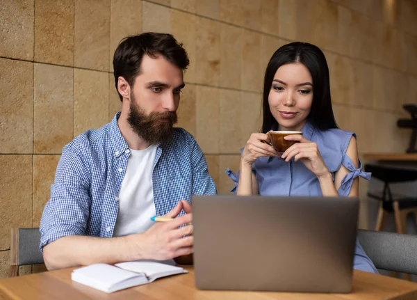 Colleagues watching training courses online using laptop computer, internet, modern technology. Students studying, working project together, learning language, exam preparation, cooperation. Online education concept