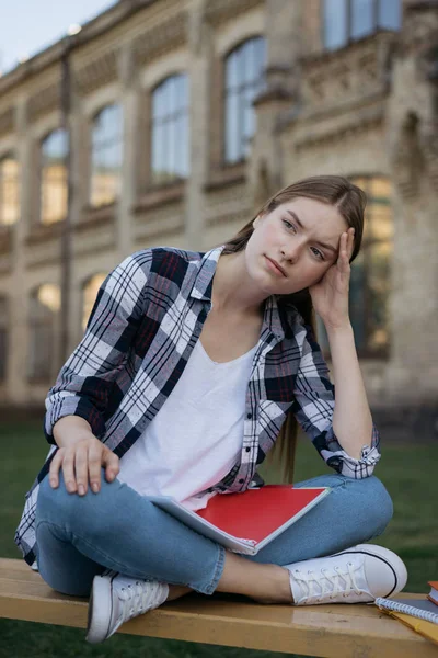 Student disappointed by exam results.   Portrait of unhappy woman with tired, sad face sitting on bench, she loosing hope. Exams failure concept