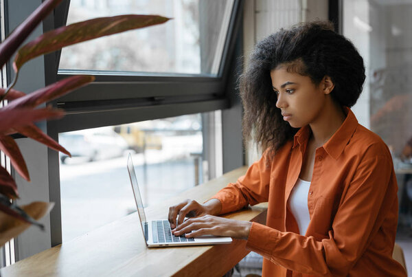 Businesswoman using laptop computer, working project, planning strategy, sitting in office. Portrait of freelancer copywriter typing on keyboard, searching information on website. Successful business and career concept 