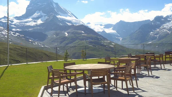 Empty Restaurant Tables and Chairs On Top Of Mountain With Beautiful View